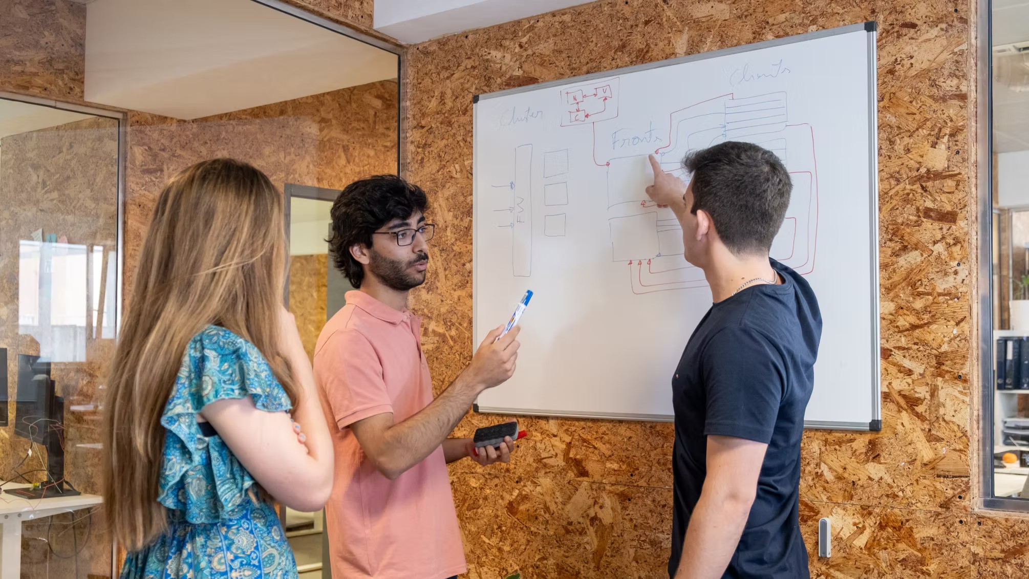 Group of young people working together and focusing on solving programming problems at Premium Minds' office