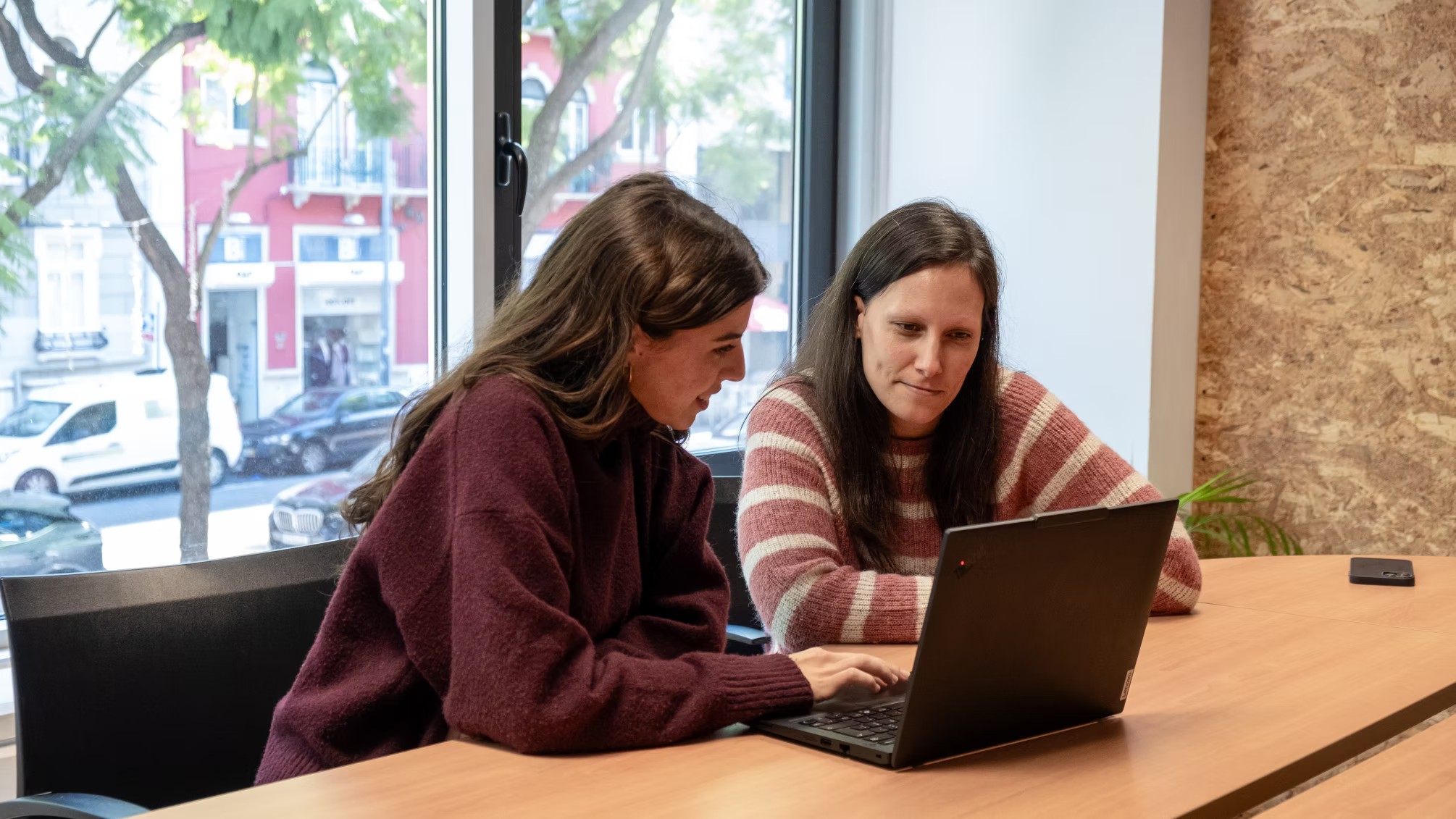 Group of young people working together and focusing on solving programming problems at Premium Minds' office